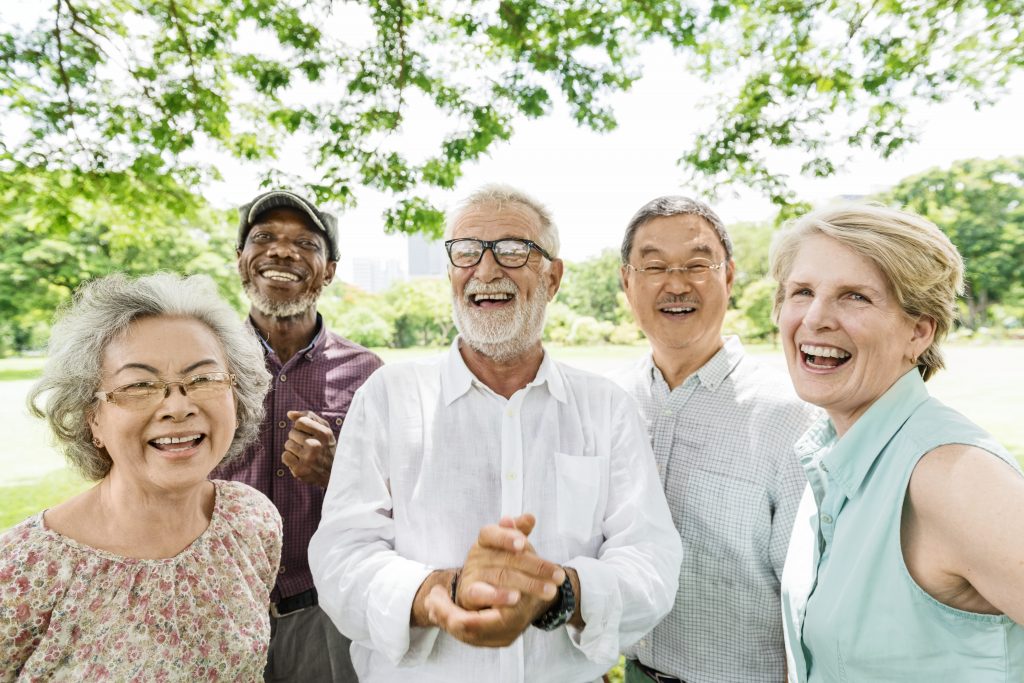 Group of Senior Retirement Friends Happiness Concept Medicare Insurance Forms